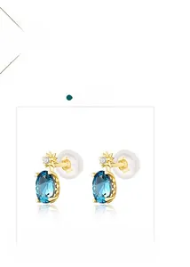Detail of s925 silver stud earrings with oval blue topaz and tiny star diamond accents