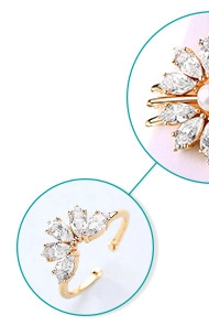 Detail of gold-plated silver ring with marquise-cut zircons and elegant pearl accents
