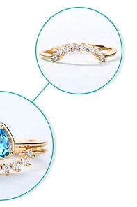Macro view of stacked 18K gold S925 silver rings with pear-cut blue gemstone and pavé diamonds