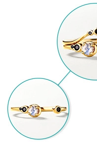 Macro detail of gold-plated silver ring featuring blue moonstone and black spinel accents