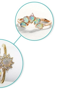 Detailed view of pear-cut blue topaz and opal stones in gold-plated silver crown settings