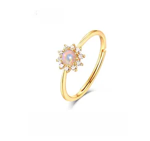 Macro detail of sunflower ring with opal center and white zircons in 9K gold plating