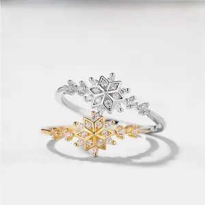 Macro shot of silver and gold snowflake rings with sparkling cubic zirconia pavé setting