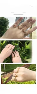 Detail view of stacked gold-plated brass rings set with pink crystals and opals