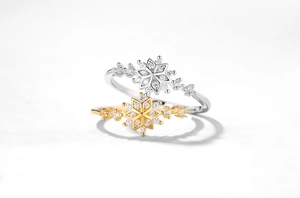 Macro view of S925 sterling silver snowflake rings with gold and silver sparkling finishes