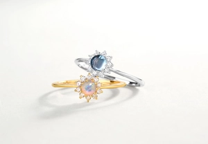 Detail of sunflower rings with opal and blue sapphire set in gold and silver plating