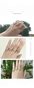 Detailed view of stacked bohemian rings with opal and turquoise on a model's hand
