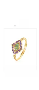 Macro detail of vintage gold opal ring with purple enamel and floral carvings
