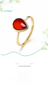 Detail of S925 sterling silver stamp on golden water-drop red garnet ring