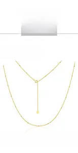 Detail of 9K gold plated bead chain necklace with heart charm on a white background
