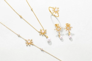 Close-up of vintage sterling silver jewelry set with pearls and snowflake design