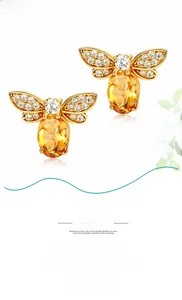 Detailed close-up of 925 silver gold-plated bee earrings with yellow citrine and crystals