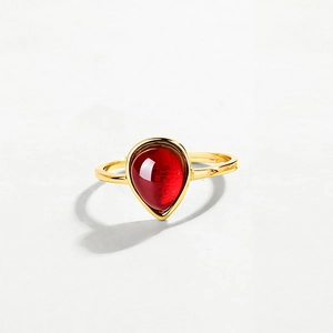 Elegant sterling silver open ring featuring a pear-cut natural red garnet in gold plating