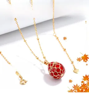 Detailed close-up of 925 sterling silver lobster clasp and heart tag on gold chain