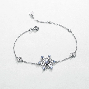 Silver snowflake bracelet with blue spinel and white zircon stones in a circular layout