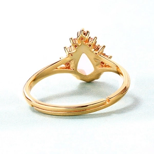 Macro detail of S925 crown ring with water drop pink gemstone and adjustable gold band