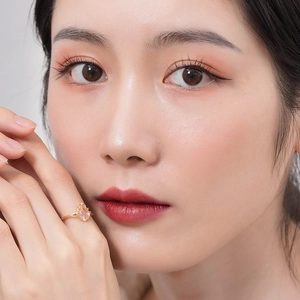 Rose gold pear-cut pink quartz ring with diamonds on model's hand with warm lighting