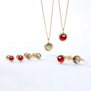 925 silver gold plated jewelry set with garnet and labradorite stones on white background