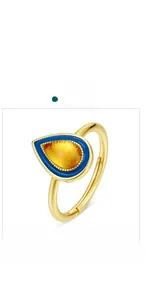 Detail of a vintage-style teardrop gold-plated ring with blue enamel and amber resin