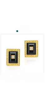 Macro shot of rectangular black onyx earrings with gold embossed texture and zircon