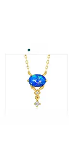 Macro detail of oval blue opal necklace with sparkling white gemstones in gold plating