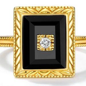 Macro shot of vintage gold-plated ring with black agate stone and wheat pattern details