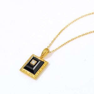 Vintage gold plated silver necklace featuring a rectangular black agate pendant with diamond