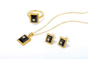 Detail of vintage Art Deco jewelry set with black agate inlay and gold plating