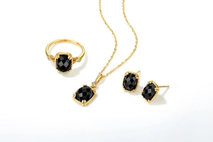 Detail of vintage gold plated sterling silver jewelry set with faceted black agate stones