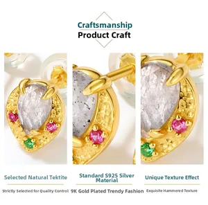 Macro view of pear-cut labradorite earring with ruby and gold hammered texture
