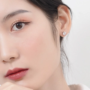 Boucles d'oreilles élégantes en argent 925 avec zircone ronde portées par un mannequin