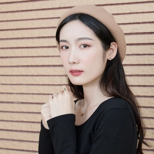 Asian model wearing a gold teardrop jewelry set with blue and yellow gradient stones