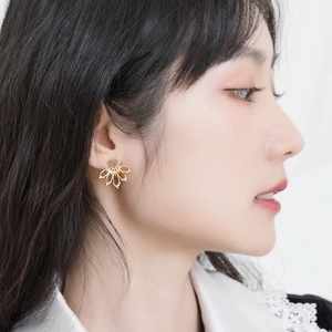 Handmade sterling silver gold plated floral earrings with natural grey gemstone on model