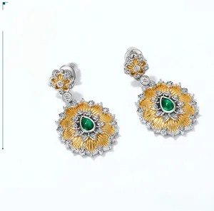 Macro detail of sunflower earrings with green gemstone and sparkling zircons
