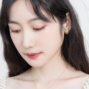 Detail of vintage heart stud earrings and necklace with quilted texture in gold finish