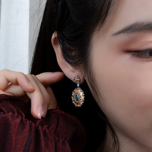 Retro sunflower earrings with green agate and 925 silver plating on model