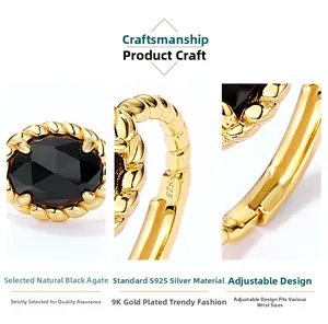 Macro detail of S925 silver twist band and oval black agate on an adjustable gold ring