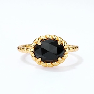 Detail of vintage gold twisted rope ring featuring an oval faceted black onyx gemstone