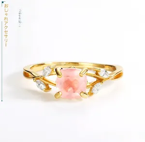 Detail of S925 sterling silver stamp and pink quartz cushion cut stone on leaf ring