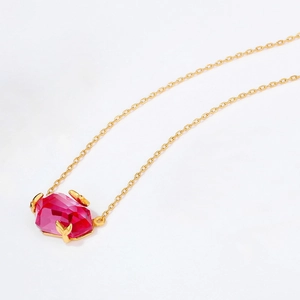 Minimalist silver necklace with pink topaz pendant and leaf claw gold chain