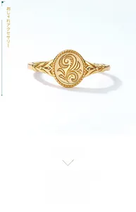Detail of a 9K gold-plated silver ring with leaf patterns and floral engraving