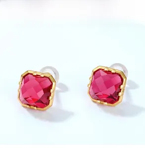 Macro shot of princess cut red corundum stud earrings with 9K gold plated silver prongs