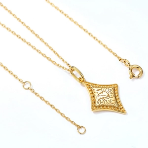Detail of s925 silver gold plated necklace featuring floral engraving on diamond pendant