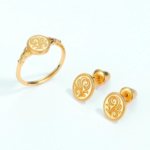 Vintage leaf pattern 925 silver 9K gold plated ring and earrings set on white background