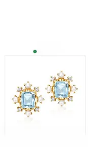 Detailed view of rectangle cut blue topaz stud earrings with pearls and gold plating