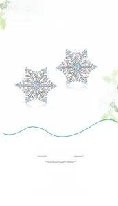 Macro detail of S925 silver snowflake drop earrings with light blue gemstone and zircons