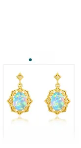 Detail of vintage 925 silver gold-plated stud earrings with synthetic oval opal stones