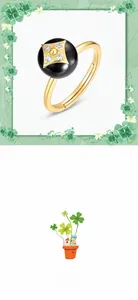 Close-up of black onyx bead ring with zircon-studded golden clover and adjustable band