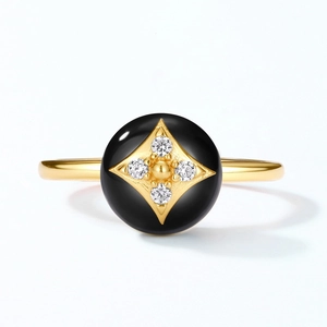 Detailed macro view of black onyx clover ring with a gold starburst and inlaid crystals