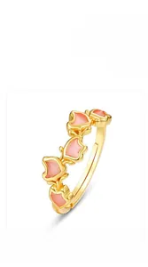 Detail view of gold open ring with four pink butterfly enamel charms and adjustable band